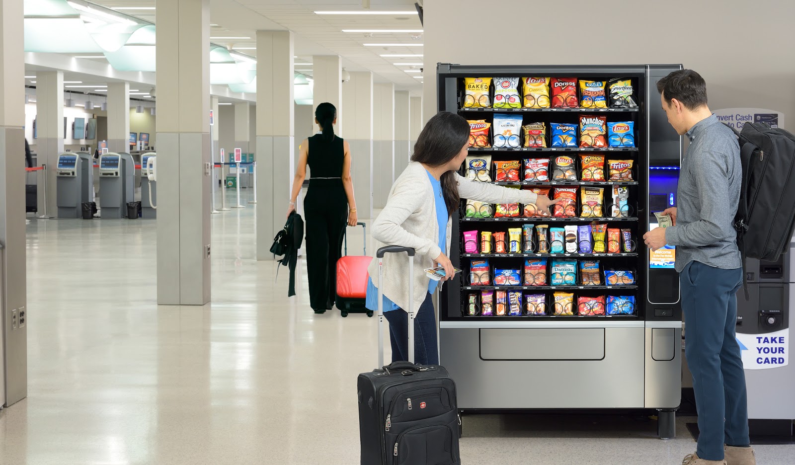 woman using vending machine at airport